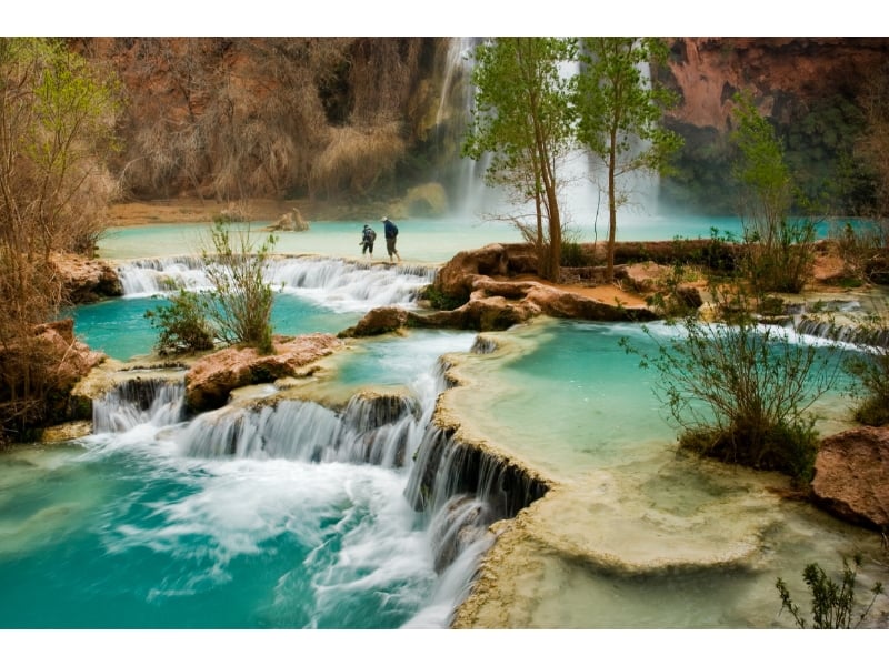Two people are enjoying the hike in Havasu falls to the extent that even the one who saws this place virtually wants to vistit this place atleast once in their life.