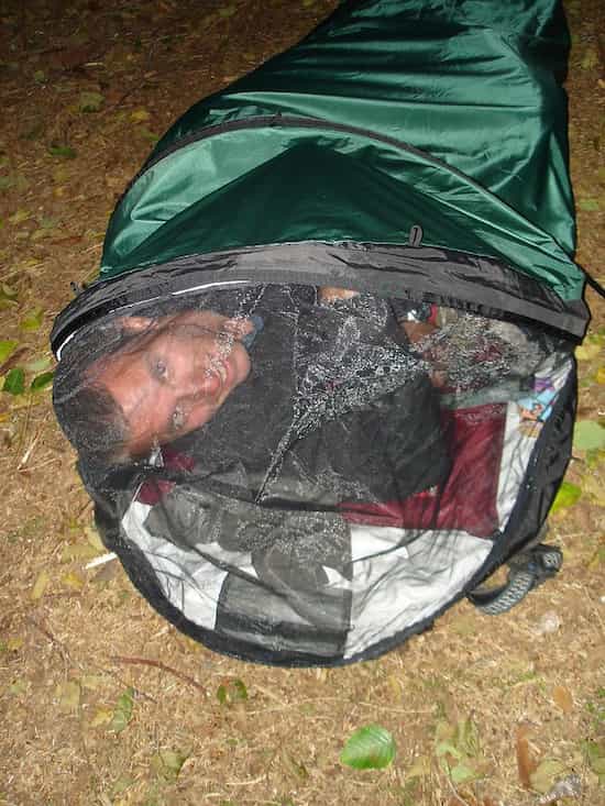 a man sleeping in his bivy sack during his camping trip