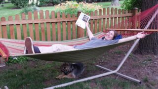 a man lying on a hammock thinking how expensive a stand can it be