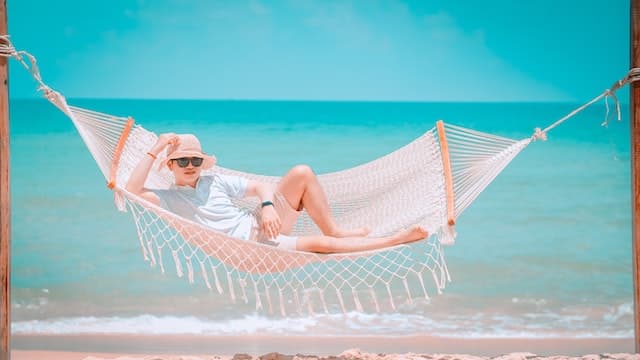A boy wearing white clothes is lying on a white hammock 

How to choose the best hanging distance for hammock.